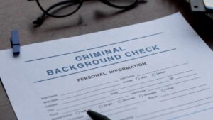 Criminal background check form on a desk during tenant screening review