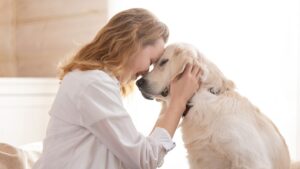 Renter sitting with a dog in a bright home during a pet screening discussion