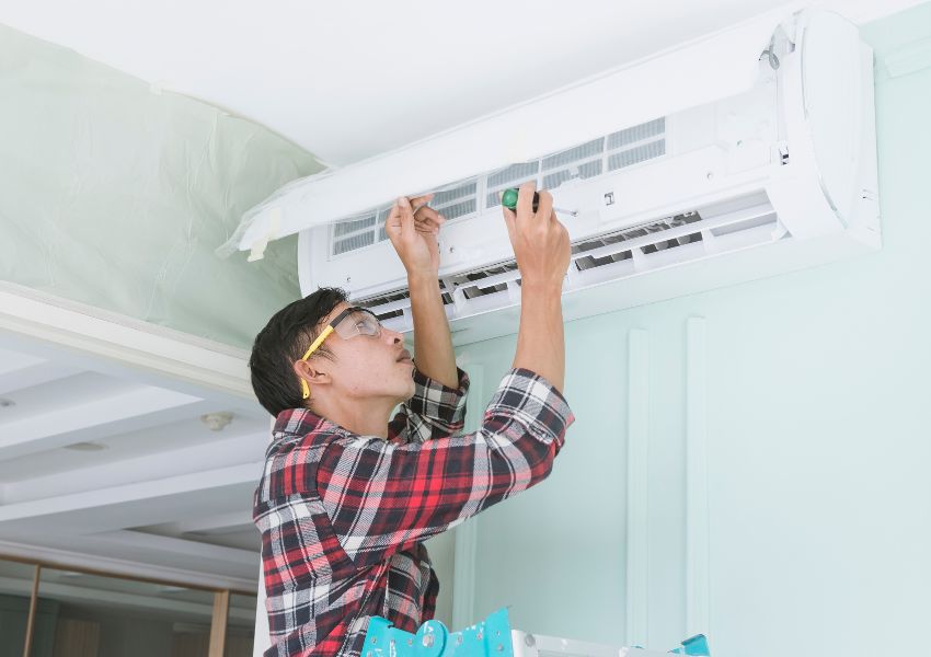 inspector checking an air conditioner